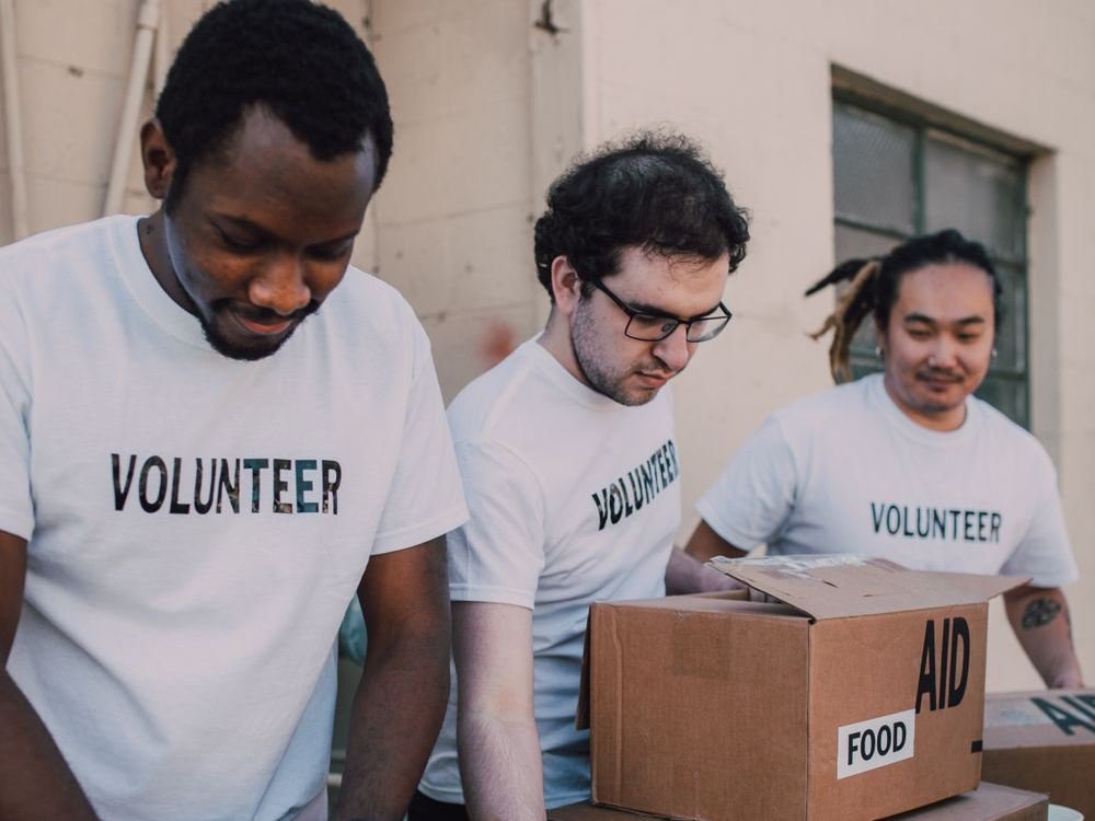 Volunteers packing boxes of food and medicine